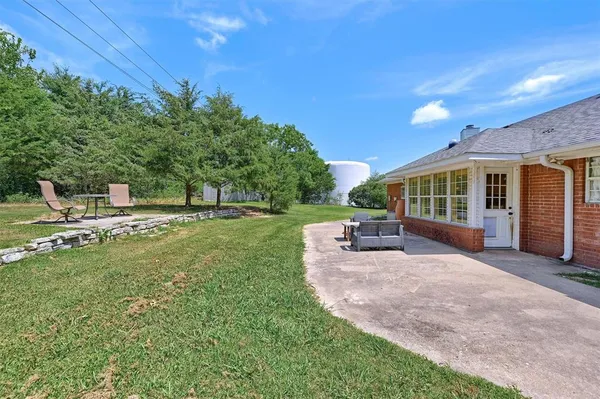 a view of a house with backyard porch and sitting area