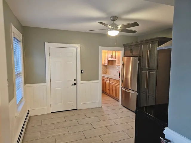 a kitchen with a refrigerator and chandelier