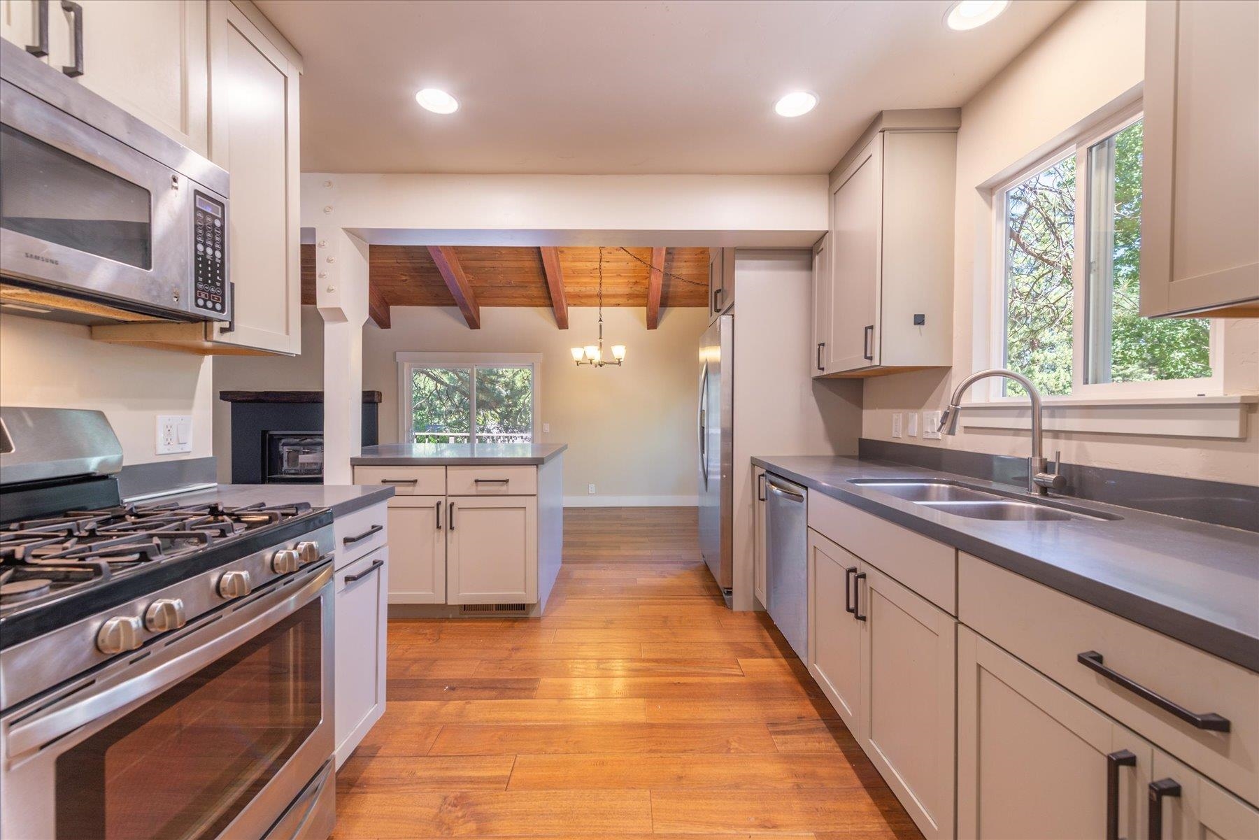 10644 Codogan Street Truckee, CA 96161 - Photo 11 of 28 a kitchen with stainless steel appliances granite countertop a stove a sink and a microwave