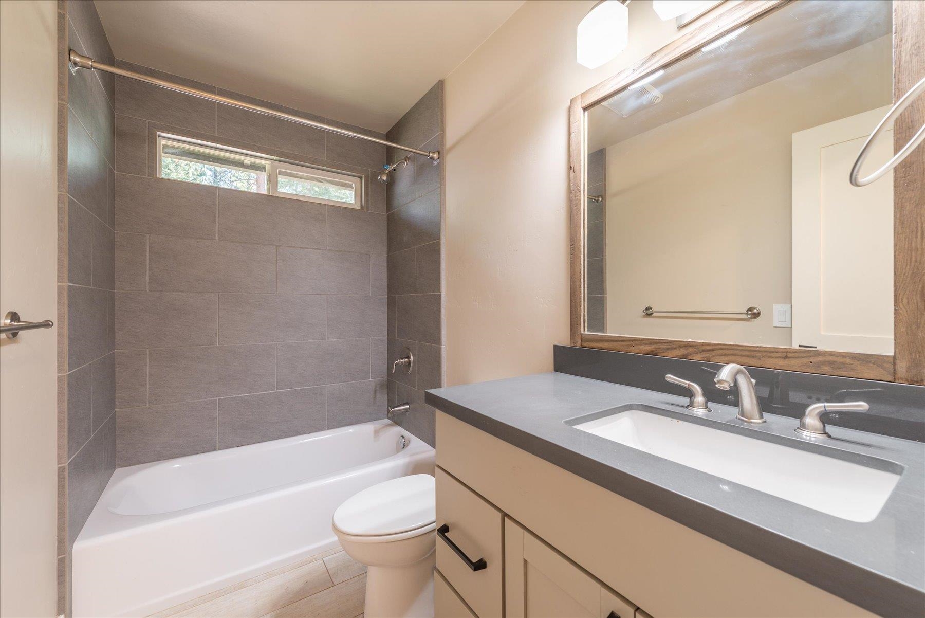 10644 Codogan Street Truckee, CA 96161 - Photo 15 of 28 a bathroom with a granite countertop sink toilet and shower