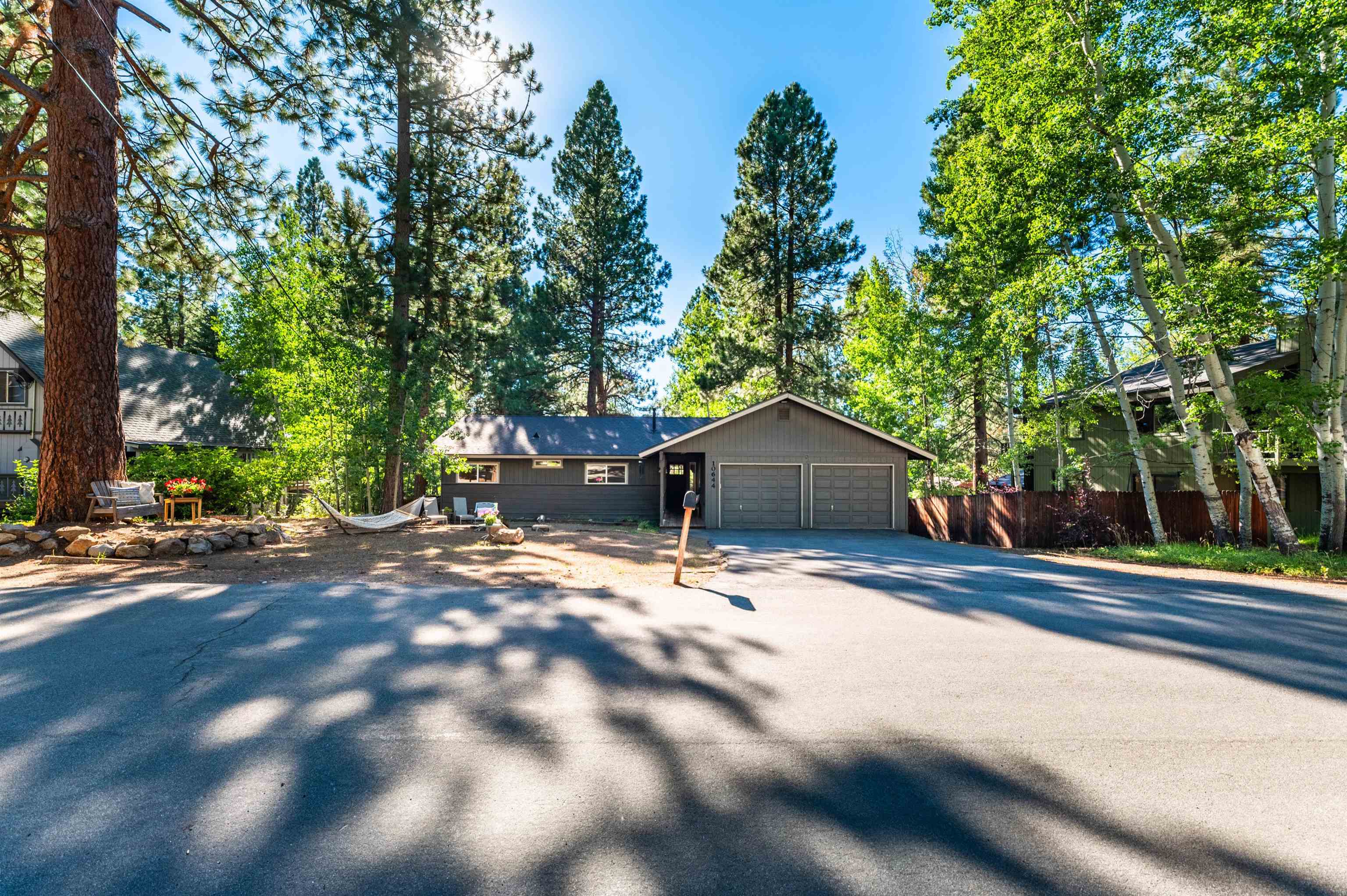 10644 Codogan Street Truckee, CA 96161 - Photo 2 of 28 a view of a house with a yard and large trees