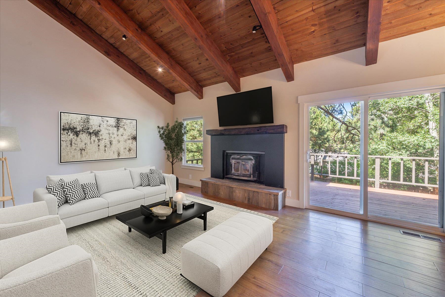 10644 Codogan Street Truckee, CA 96161 - Photo 7 of 28 a living room with furniture a flat screen tv and a fireplace