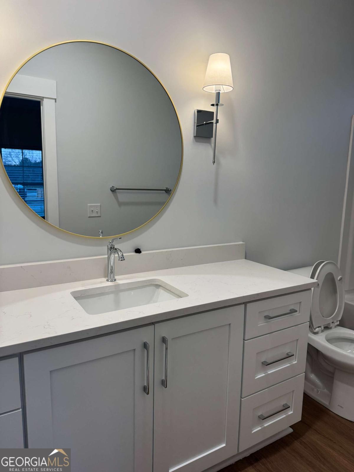 350 Rucker Lane, Unit AB Statesboro, GA 30458 - Photo 16 of 20 a bathroom with a sink and a mirror