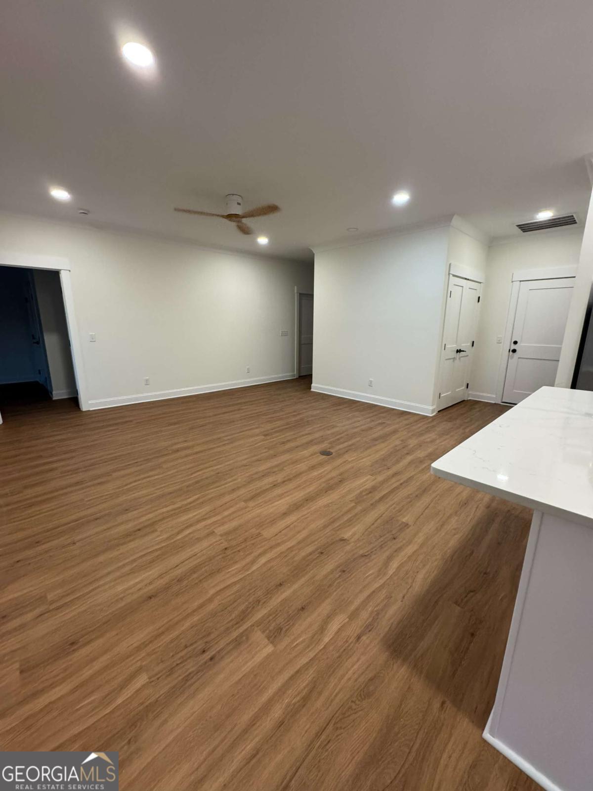 350 Rucker Lane, Unit AB Statesboro, GA 30458 - Photo 4 of 20 an empty room with wooden floor and windows