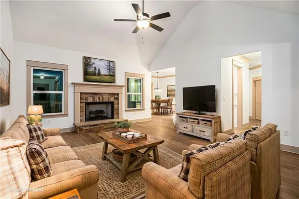 a living room with furniture a flat screen tv and a fireplace