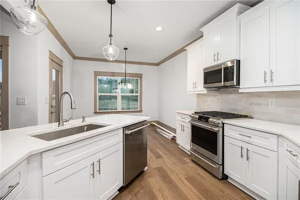 a kitchen that has a sink and a stove