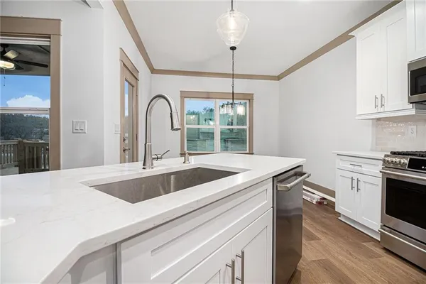 a kitchen with a sink and a stove top oven