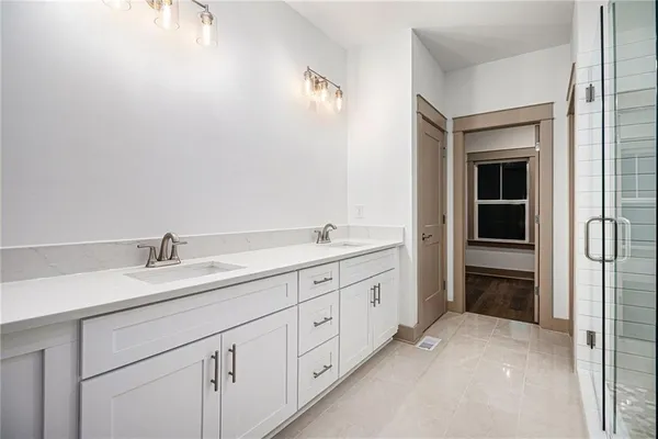 a spacious bathroom with 2 sink and a vanity