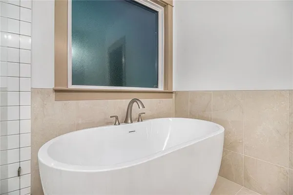 a white bath tub sitting in a bathroom