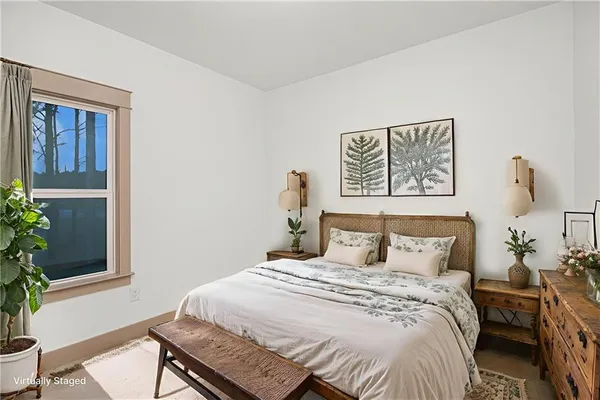 a bedroom with a bed and a potted plant