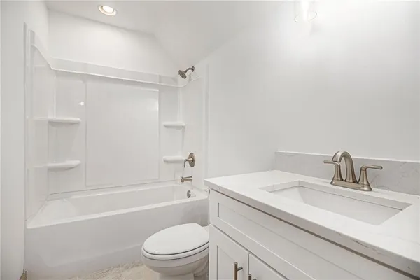 a bathroom with a sink toilet vanity and shower