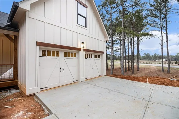 a view of a parking space with wooden fence