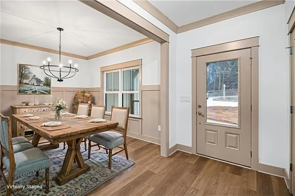 a view of a dining room with furniture window and wooden floor