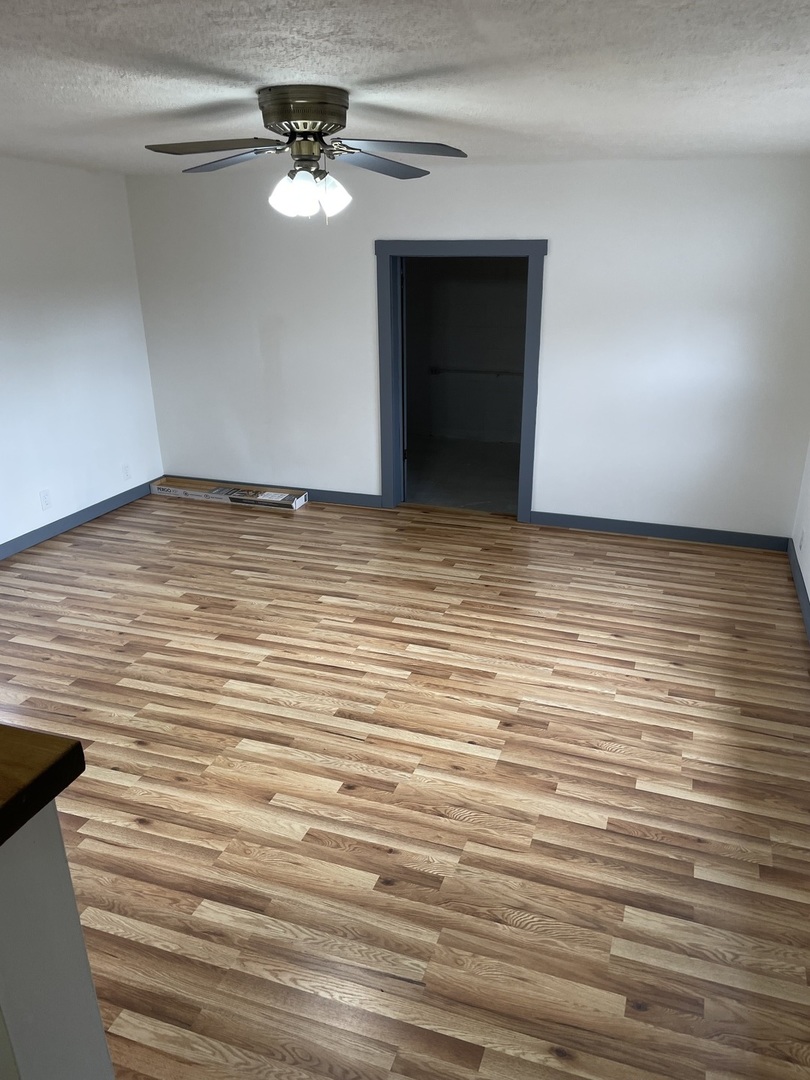 746 Mt Mission Road Metropolis, IL 62960 - Photo 15 of 24 a view of a room with wooden floor and a ceiling fan