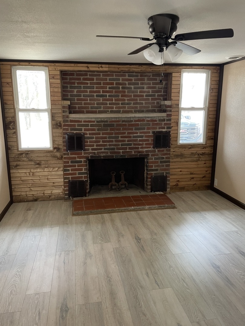 746 Mt Mission Road Metropolis, IL 62960 - Photo 19 of 24 a view of an empty room with wooden floor fireplace and a window