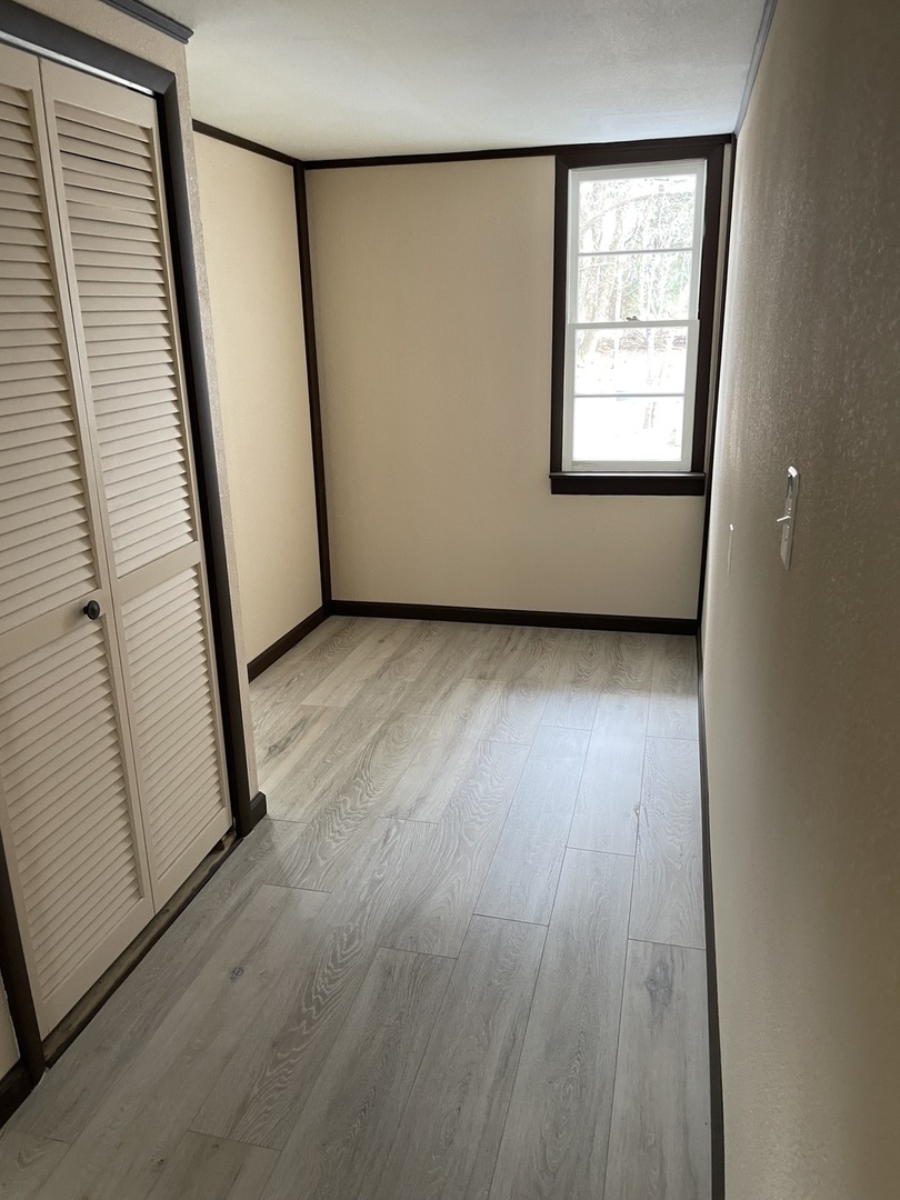 746 Mt Mission Road Metropolis, IL 62960 - Photo 20 of 24 an empty room with wooden floor and windows