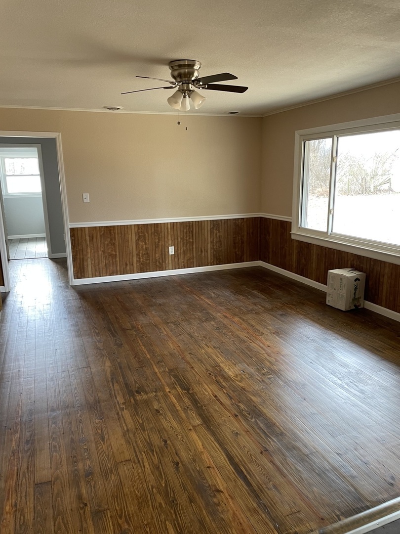 746 Mt Mission Road Metropolis, IL 62960 - Photo 3 of 24 an empty room with wooden floor and windows