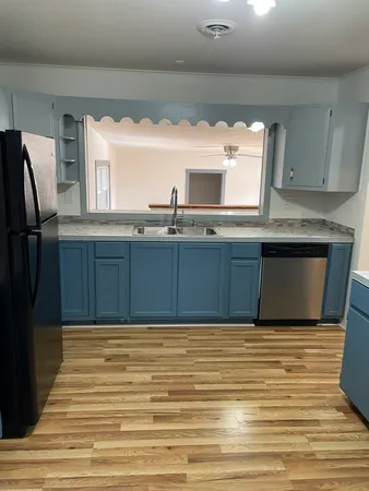 a view of kitchen with wooden floor and window