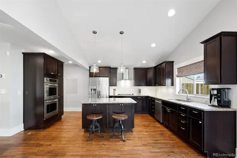 a large kitchen with a table and chairs in it