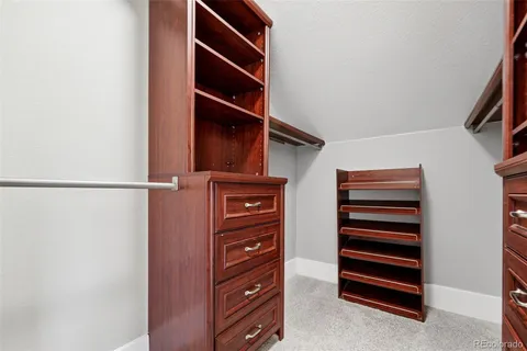 a view of walk in closet with empty racks