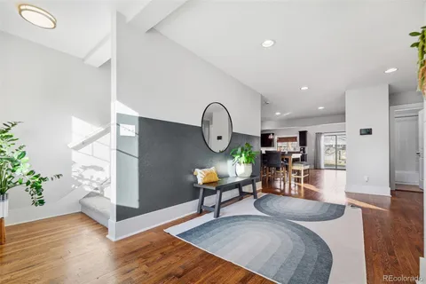 a living room with furniture rug and wooden floor
