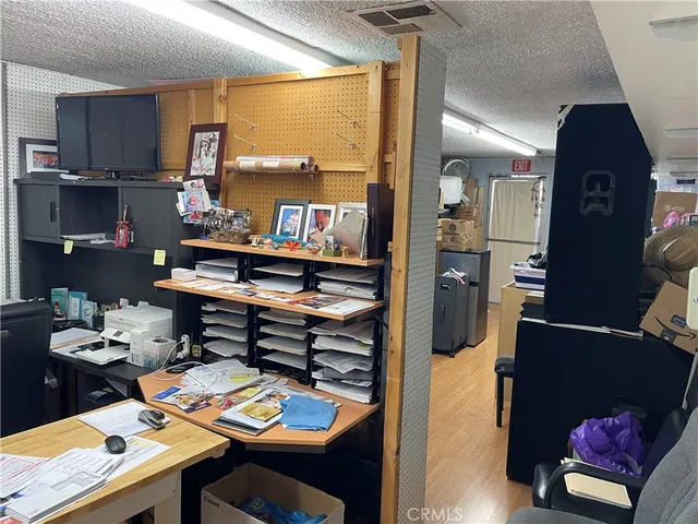 a kitchen with a refrigerator stove and wooden floor