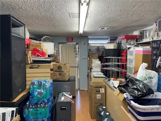 a kitchen with stainless steel appliances kitchen island granite countertop a refrigerator and cabinets