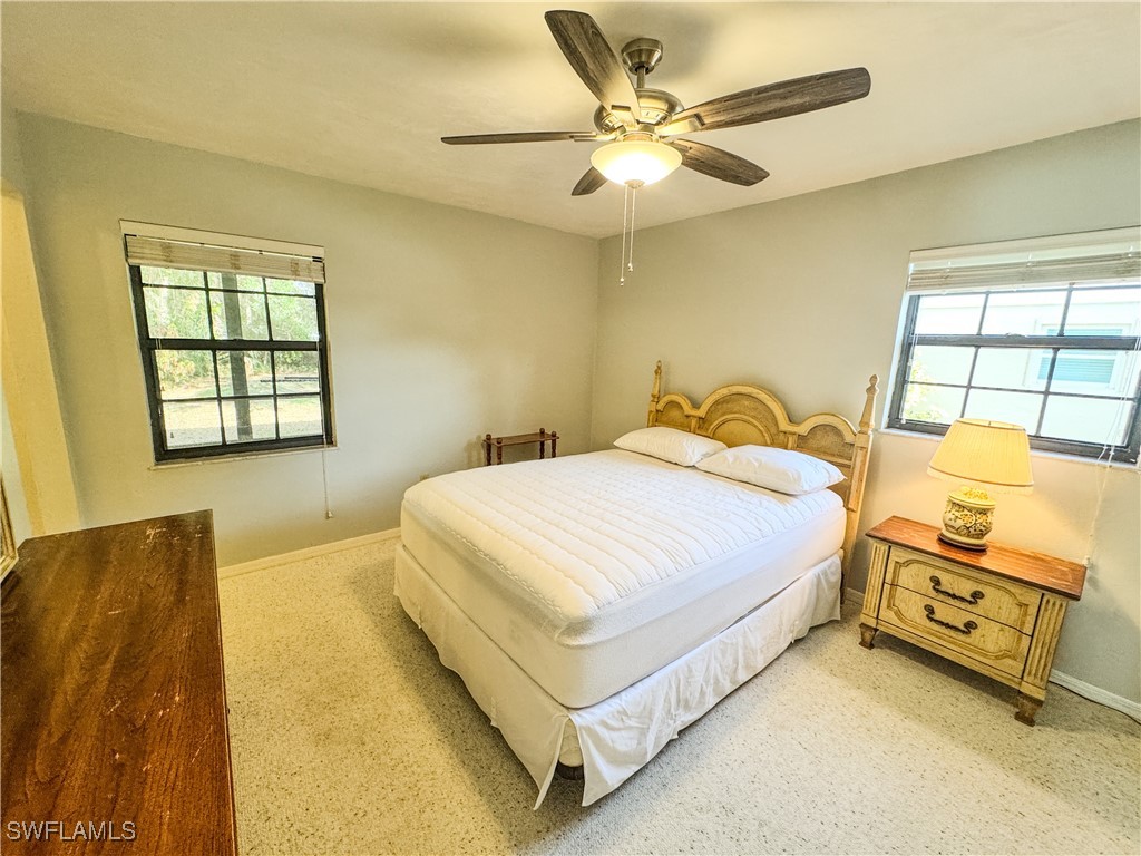 75 Hardee Street LaBelle, FL 33935 - Photo 13 of 24 a bedroom with a bed and a couch