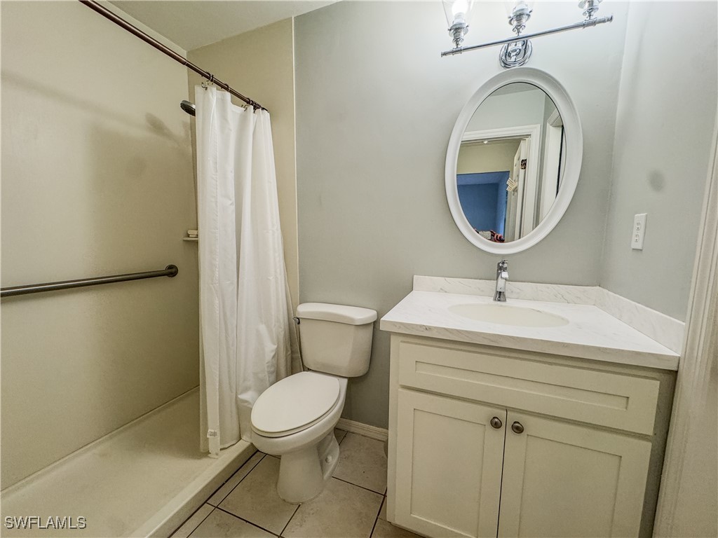 75 Hardee Street LaBelle, FL 33935 - Photo 21 of 24 a bathroom with a sink a toilet and a mirror