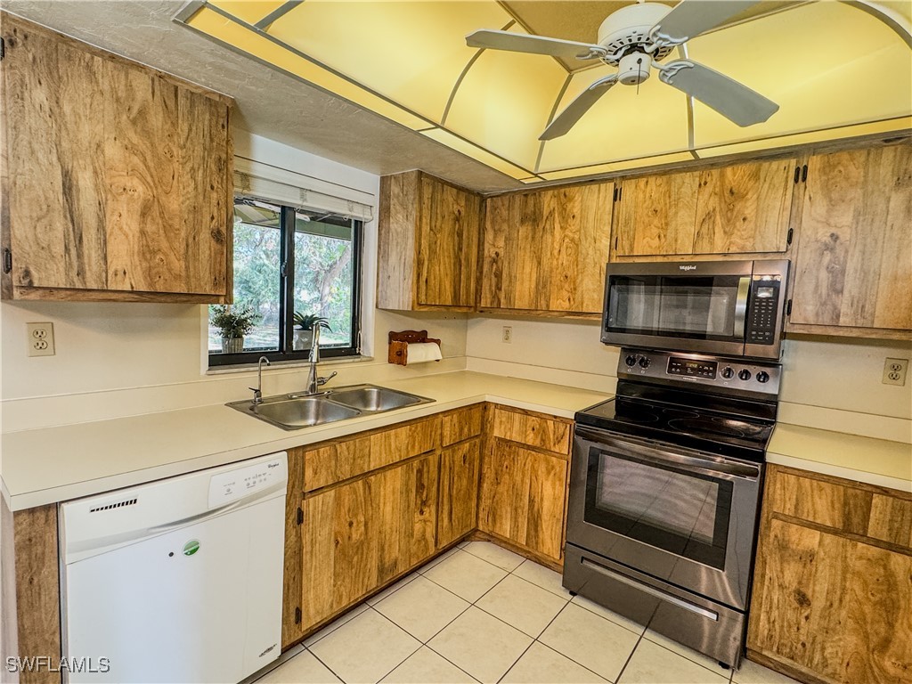 75 Hardee Street LaBelle, FL 33935 - Photo 10 of 24 a kitchen with a sink cabinets and stainless steel appliances