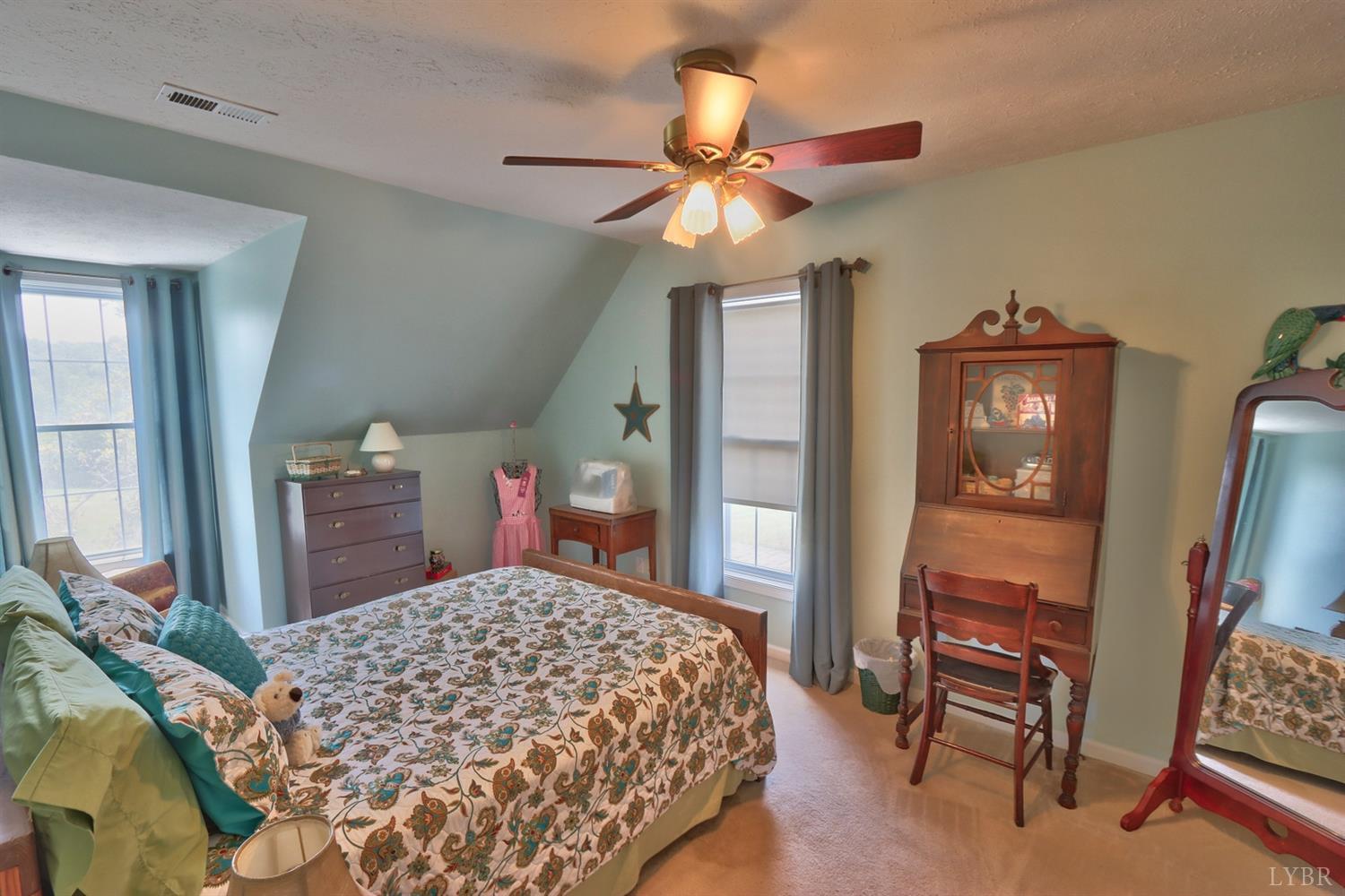 5357 Elon Road Monroe, VA 24574 - Photo 58 of 59 a bedroom with a bed and a chandelier