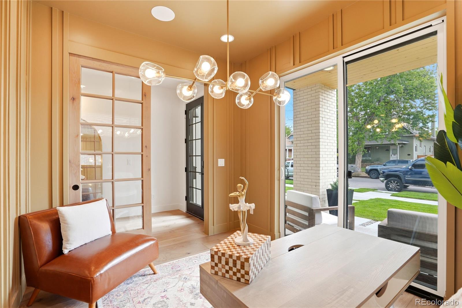 245 South Emerson Street Denver, CO 80209 - Photo 11 of 49 a living room with furniture a chandelier and a large window