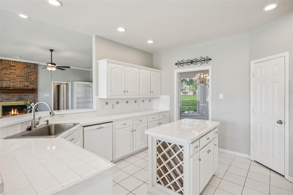 1107 Ruidoso Downs Drive Talty, TX 75160 - Photo 11 of 33 a kitchen with granite countertop a sink cabinets and window