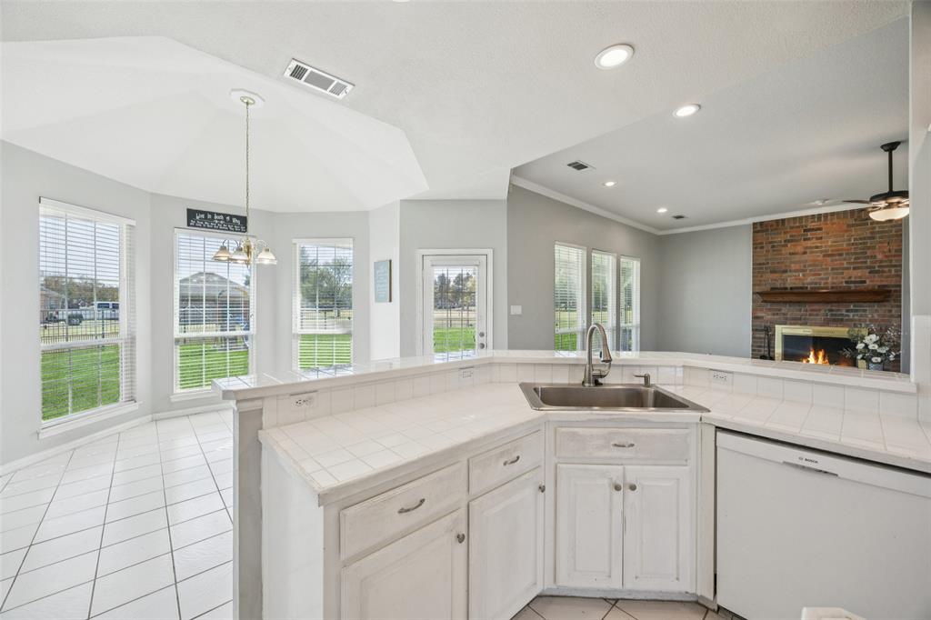 1107 Ruidoso Downs Drive Talty, TX 75160 - Photo 13 of 33 a kitchen with sink and window