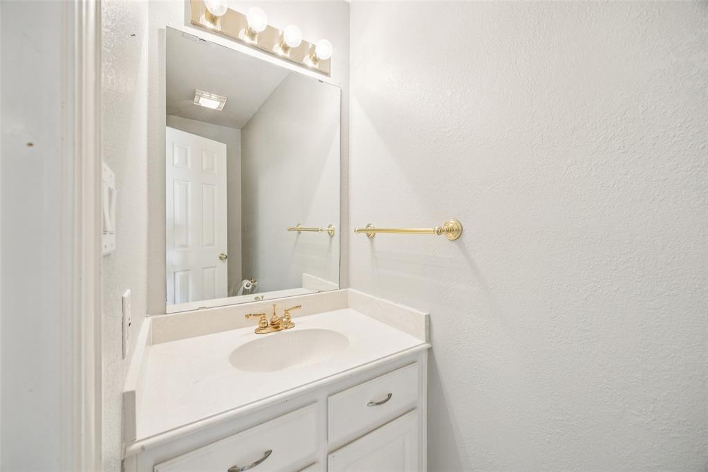 1107 Ruidoso Downs Drive Talty, TX 75160 - Photo 14 of 33 a bathroom with a sink and a mirror