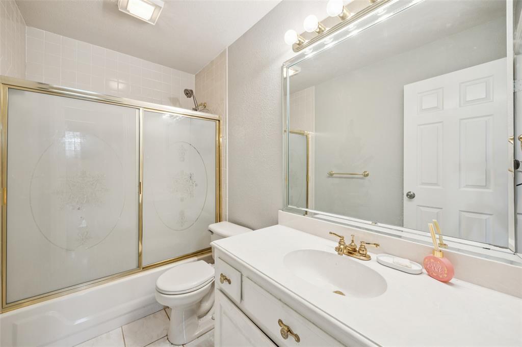 1107 Ruidoso Downs Drive Talty, TX 75160 - Photo 15 of 33 a bathroom with a sink toilet tub and shower