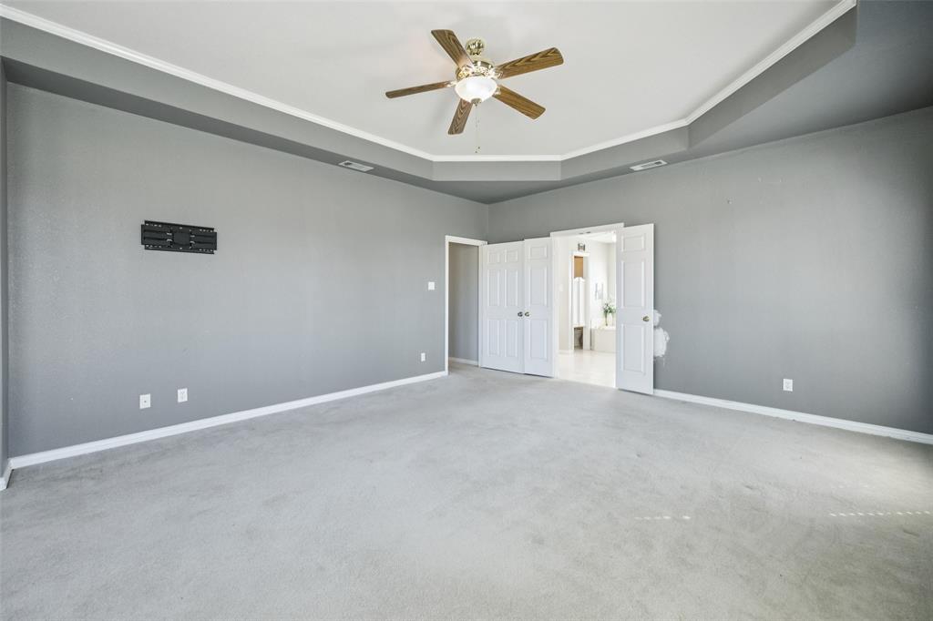 1107 Ruidoso Downs Drive Talty, TX 75160 - Photo 22 of 33 a view of an empty room with a ceiling fan