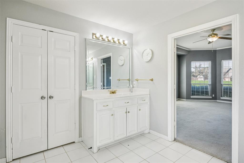 1107 Ruidoso Downs Drive Talty, TX 75160 - Photo 24 of 33 a spacious bathroom with a mirror sink and vanity