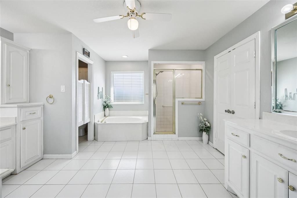 1107 Ruidoso Downs Drive Talty, TX 75160 - Photo 25 of 33 a bathroom with a tub shower vanity and a sink