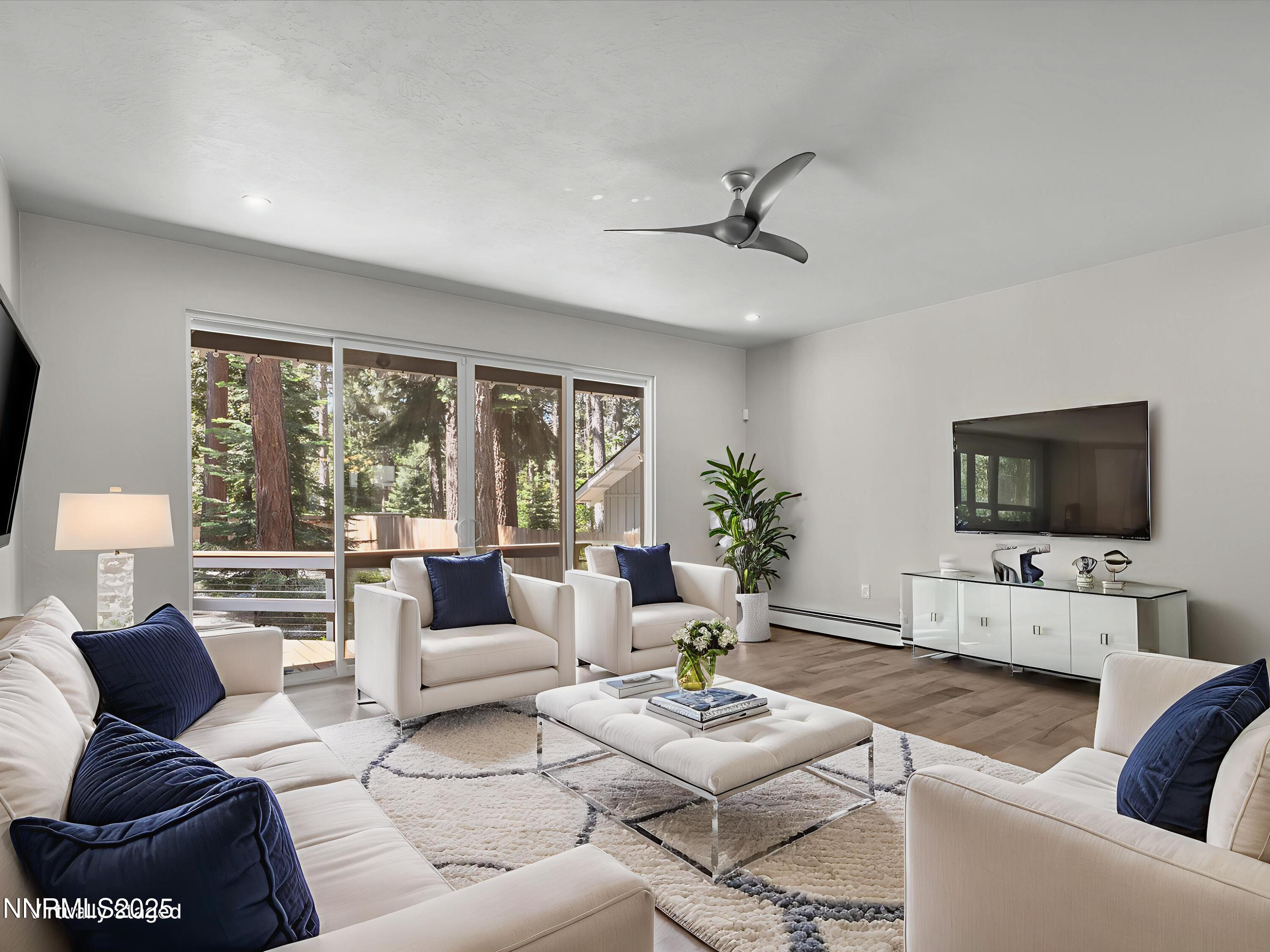 189 Ray Way Zephyr Cove, NV 89448 - Photo 11 of 71 a living room with furniture a flat screen tv and a large window