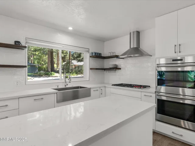 a utility room with cabinets washer and dryer