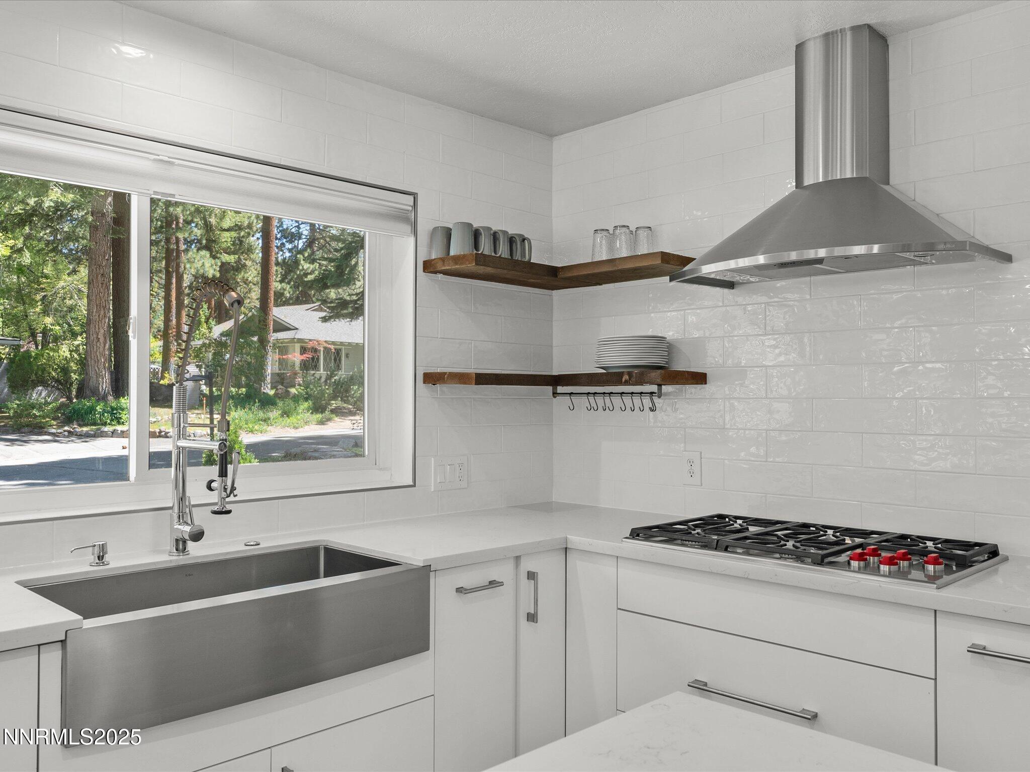 189 Ray Way Zephyr Cove, NV 89448 - Photo 18 of 71 a kitchen with stainless steel appliances a sink a stove and a window