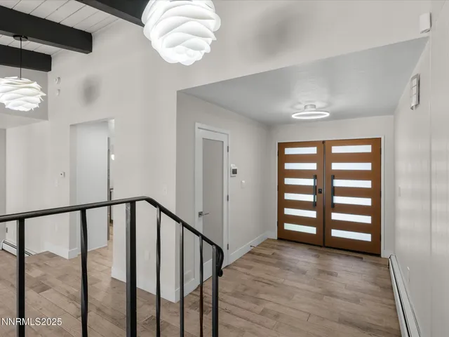 a view of a livingroom with wooden floor and a flat screen tv