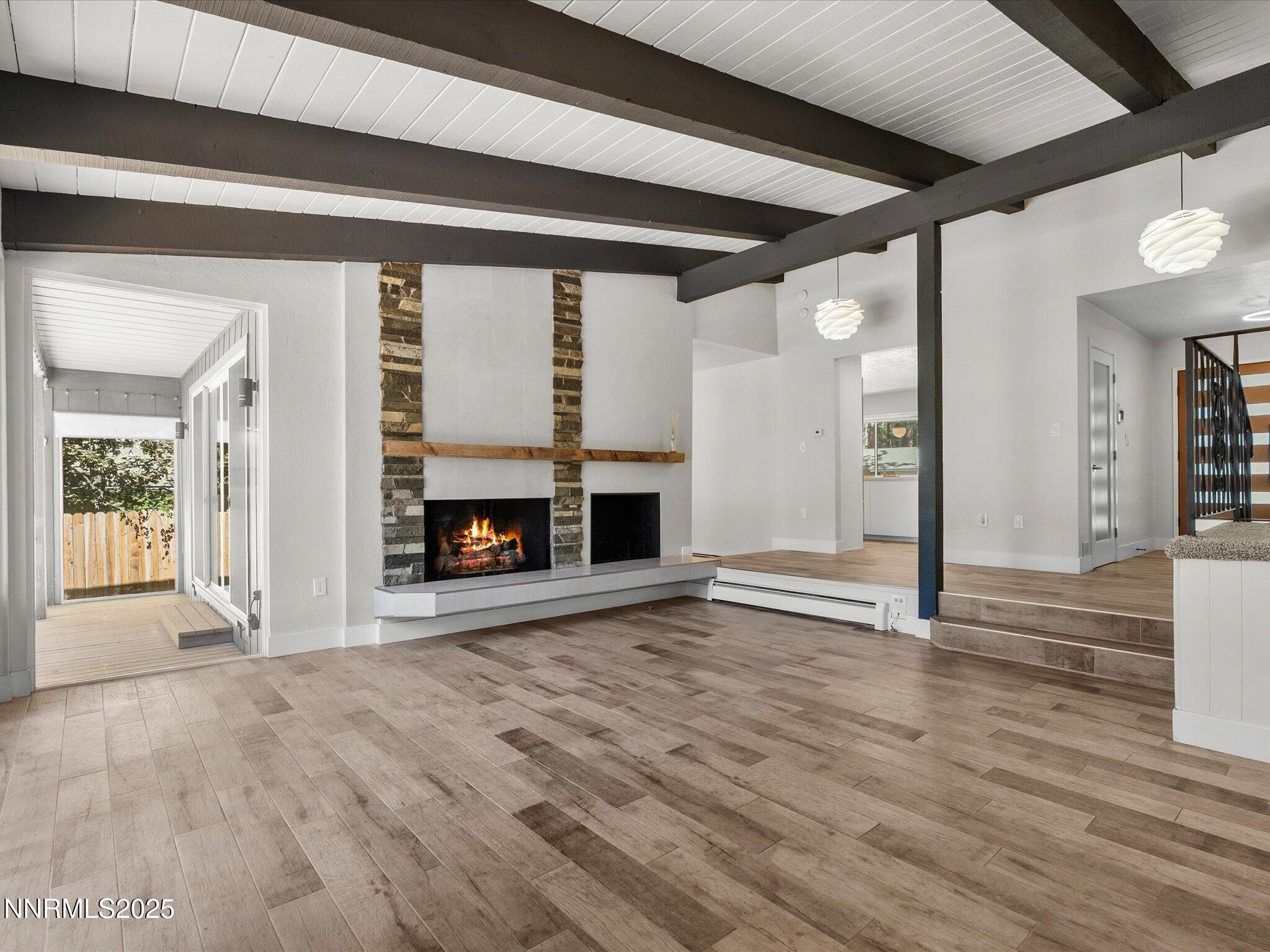 189 Ray Way Zephyr Cove, NV 89448 - Photo 10 of 71 a view of an empty room with wooden floor and a fireplace