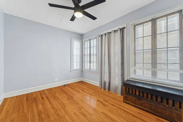 a view of a room with wooden floor and windows