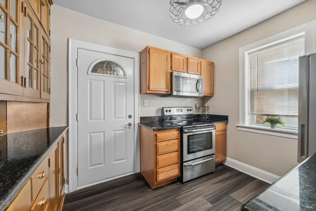 a kitchen with stainless steel appliances granite countertop a stove and a refrigerator