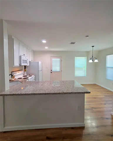 a view of a kitchen counter space and wooden floor