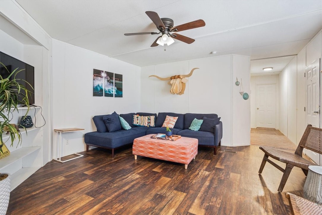 6067 Old Mexia Road Waco, TX 76705 - Photo 11 of 32 a living room with furniture and a wooden floor