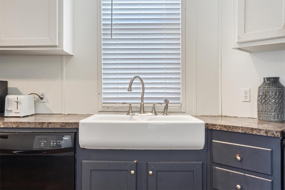 6067 Old Mexia Road Waco, TX 76705 - Photo 17 of 32 a kitchen with granite countertop a sink and a stove