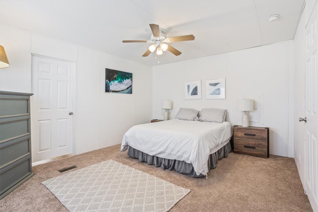 6067 Old Mexia Road Waco, TX 76705 - Photo 18 of 32 a bedroom with a bed and a ceiling fan